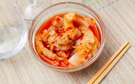 Traditional Korean side dish Kimchi of salted fermented napa cabbage seasoned with scotch bonnet peppers..