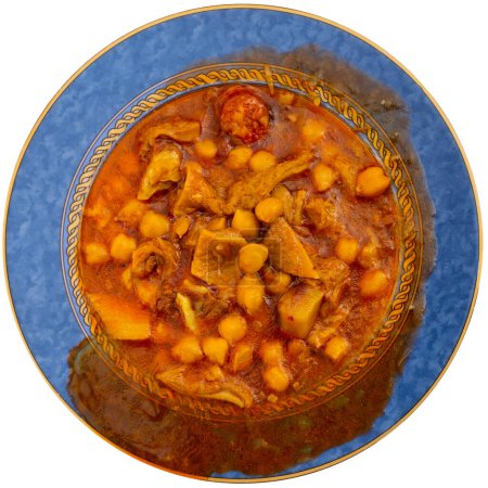 Appetizing hot tripe with chorizo and chickpeas served on plate. Isolated over white background