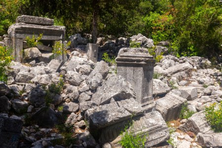 Ancient marble statue pedestal among ruins Agora of abandoned city Termessos in Turkey mountains