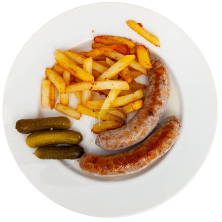 Main course for dinner is fried grilled small pork sausage and slices of french fries complemented completed with pickled gherkin cucumber. Isolated over white background