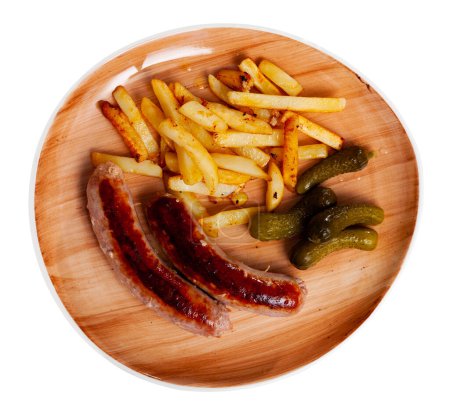 Main course for dinner is fried grilled small pork sausage and slices of french fries complemented completed with pickled gherkin cucumber. Isolated over white background