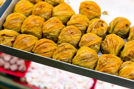 Baklava from filo pastry sweetened with honey and filled with chopped walnuts and pistachios. Traditional Turkish dessert for sale