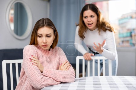 Girlfriend or sister yelling at girl during family quarrel at home