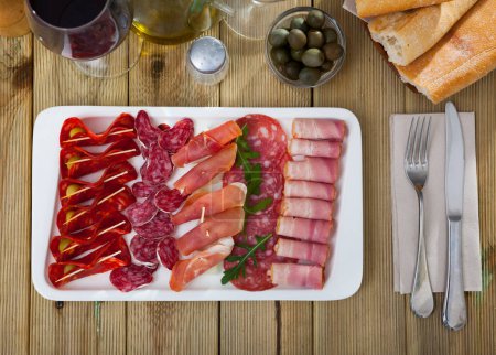 Cold smoked meat plate with traditional Spanish chorizo, fuet and salami sausages, sliced bacon and jamon