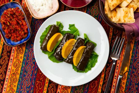 Turkish dish Yaprak sarma, stuffed with rice and spices on a white plate