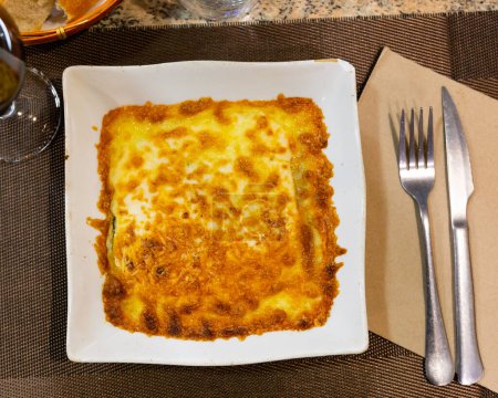 Traditional dish of Italian cuisine is meat lasagna with delicious Parmesan cheese melted on top