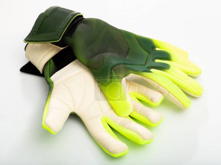 Closeup of pair of goalkeeper gloves isolated on white background. Concept of sports equipment and outfit for playing football