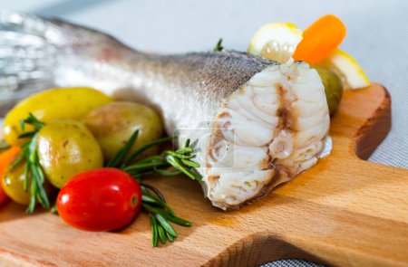 Hake baked by rustically style. Hake 250 gramm it is better to take the tail, rub it with salt and pepper, bake in the oven for 20 minutes at 220 gramm Served with potatoes and fresh vegetables