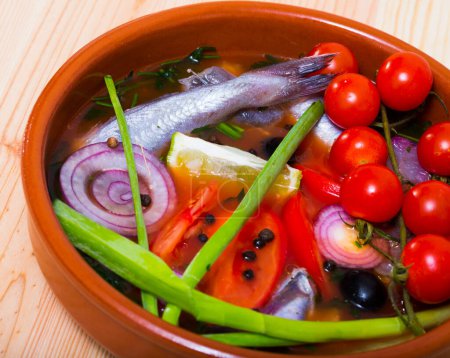 Fisherman soup of blue whiting with tomatoes, green onions and bell peppers