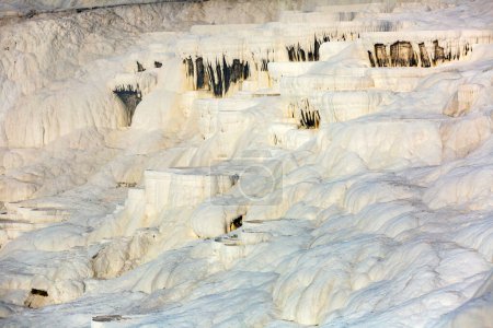 Natural travertine thermal pools and terraces with blue water at Cotton castle Pamukkale