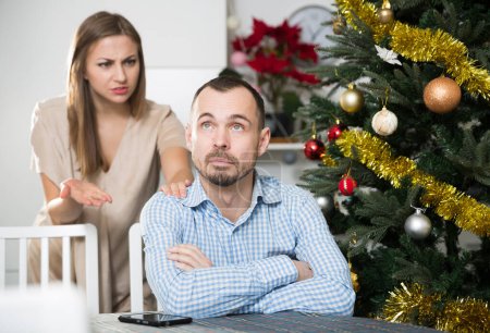 Young couple quarreling during Christmas celebration