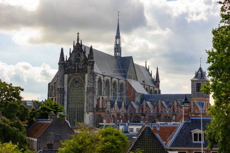 View of impressive Gothic building of medieval Hooglandse Kerk church in Dutch city of Leiden on cloudy summer day