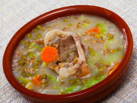 Scottish cuisine. National thick soup with lamb meat, root vegetables, pulses and barley served in clayware