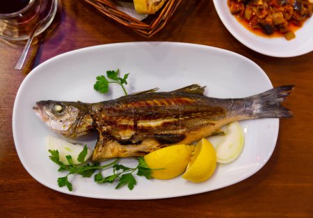 Tasty sea bass with onion, lemon and parsley. Turkish cuisine