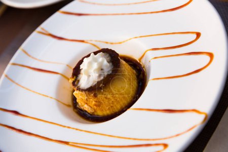 Delicate vanilla caramel flan served with whipped cream. Traditional Spanish dessert