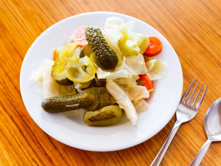 Delicious pickled vegetables on white plate, traditional turkish dish Tursu