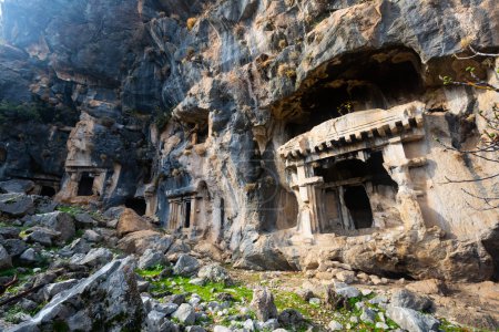 Lycian rock hewn tombs carved into mountainside in ancient Pinara city, Mugla Province, Turkey