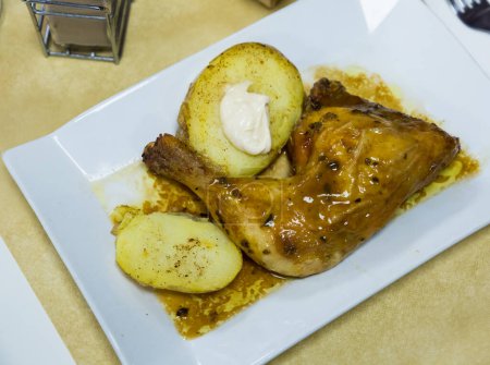 Fried chicken legs with boiled potatoes and sauce. High quality photo