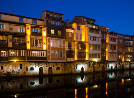 View of lighted old houses on Agout river, Castres, France
