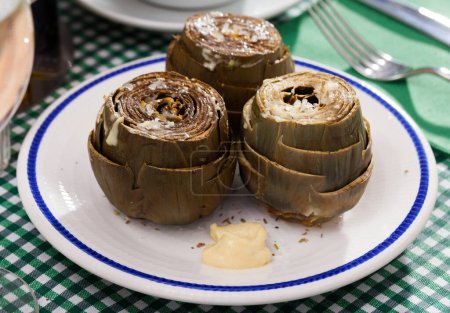 Steamed artichokes with alioli sauce. High quality photo