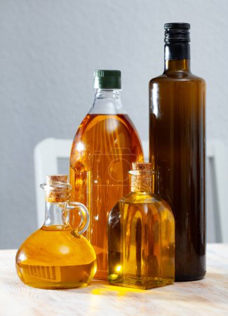 Organic vegetable oil in bottles on wooden background