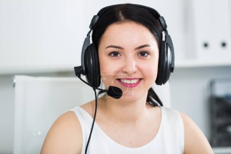Smiling female worker working effectively at call-center