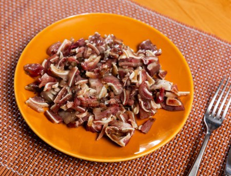 Sliced raw pork ears in seasonings served on plate