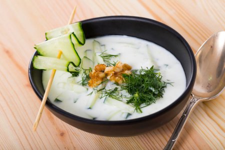 Traditional Bulgarian dish Tarator - cold soup from sour milk and cucumbers