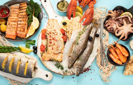 Photo for Various seafood and fishes dishes. Healthy food concept on blue background, top view - Royalty Free Image