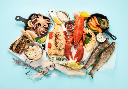 Photo for Various seafood and fishes dishes. Healthy food concept on blue background, top view - Royalty Free Image