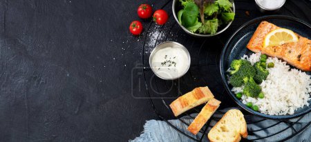 Photo for Set of various main dishes. Different healthy main courses, meat and fish dishes, pasta, salads, sauces, bread and vegetables on a dark background. Top view. Panorama with copy space. - Royalty Free Image