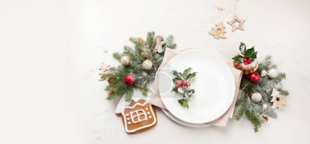 Photo for Christmas table setting with empty plate on light background. Winter Holidays conept. Top view. Copy space. Panorama, banner - Royalty Free Image