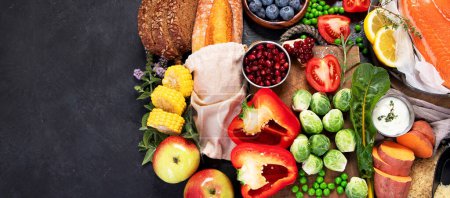 Photo for Healthy food selection on dark background. Detox and clean diet concept. Foods high in vitamins, minerals and antioxidants. Anti age foods. Top view. Panorama with copy space. - Royalty Free Image