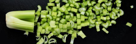 Photo for Raw celery on dark background. Healthy food. Top view, flat lay, panorama - Royalty Free Image