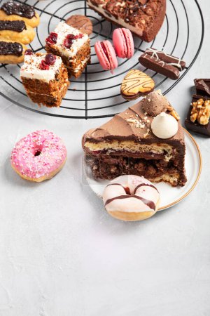 Photo for Table with various cookies, donuts, cakes and coffe cups on light backround. Top view. - Royalty Free Image
