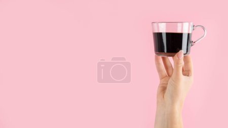 Téléchargez les photos : Bras levés tenant une tasse de café sur fond rose. Photo concept. Vue de face - en image libre de droit