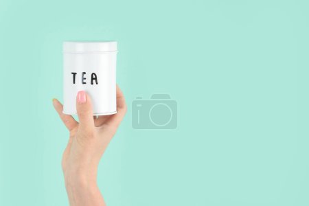 Photo for Arms raised up holding tea cup on green background. Concept photo. Front view - Royalty Free Image