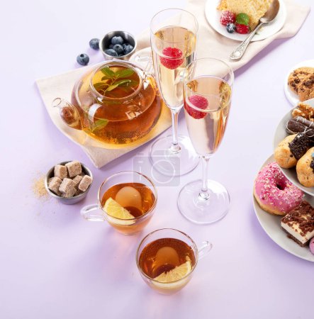 Photo for Traditional English tea. Afternoon tea with  selection of sweets  on violet background. Holiday concept - Royalty Free Image