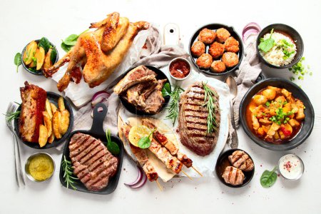 Foto de Meat main dishes. Plates of various meat. Non vegetarian food banner. Top view. - Imagen libre de derechos