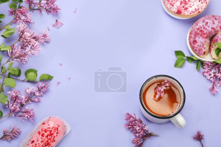 Photo for Lilac flowers with cup of tea on colourful background. Atmospheric summer concept. Top view, flat lay, copy space - Royalty Free Image