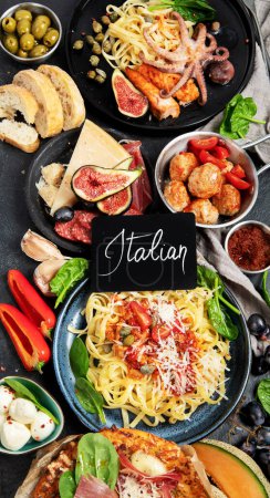 Téléchargez les photos : Dinner table of italian meals dishes.  Pizza, pasta, antipasto  on black background. Healthy eating concept. Top view - en image libre de droit