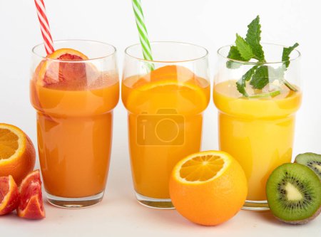 Foto de Fruit juices assortment on light background. Freshly made drinks. - Imagen libre de derechos