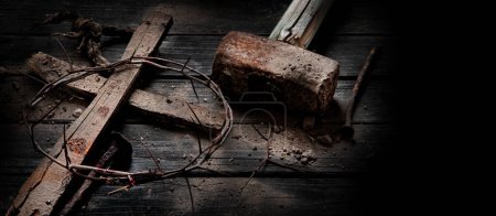 Foto de Jesus Christ  Hammer And Bloody Nails And Crown Of Thorns  on dark Background. Easter symbol concept. Top view, copy space - Imagen libre de derechos
