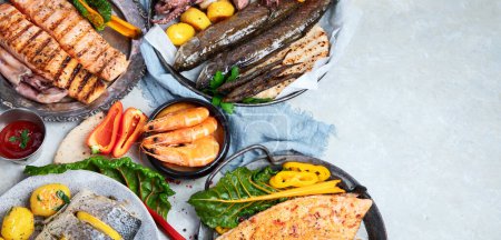 Photo for Seafood platter. Assorted delicious seafood with vegetables on a grey background. Top view. Panorama with copy space. - Royalty Free Image