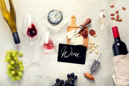Photo for Pink and red wine served with cheeses, nuts, grapes and glasses of wine. Delicious food wine snacks assorted served on boards. Flat lay on a light  background. - Royalty Free Image