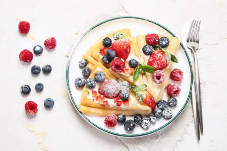 Photo for Healthy breakfast, homemade traditional crepes or pancakes with fresh berries, morning light background.  top view - Royalty Free Image