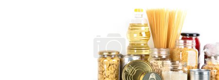 Foto de Food supplies. Crisis food stock. Different glass jars with grains, pasta, oil, nut, canned food, copy space - Imagen libre de derechos