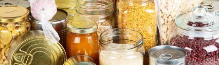 Photo for Food supplies. Crisis food stock. Different glass jars with grains, pasta, oil, nut, canned food. Panorama, banner - Royalty Free Image