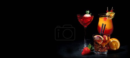 Foto de Set of various colorful cocktails on black background. Classic long drink cocktails menu concept. Copy, space - Imagen libre de derechos