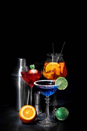 Foto de Set of various colorful cocktails on black background. Classic long drink cocktails menu concept. - Imagen libre de derechos